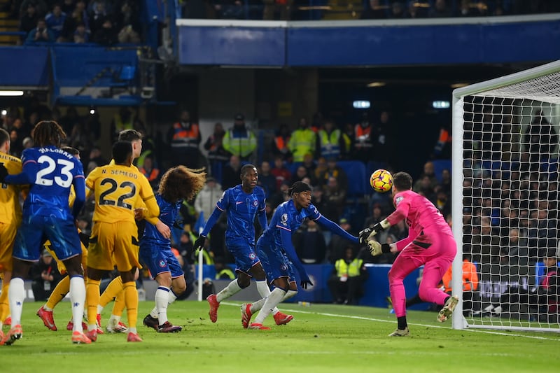 Noni Madueke of Chelsea scores his team's third goal past Jose Sa of Wolves. Photograph: Mike Hewitt/Getty