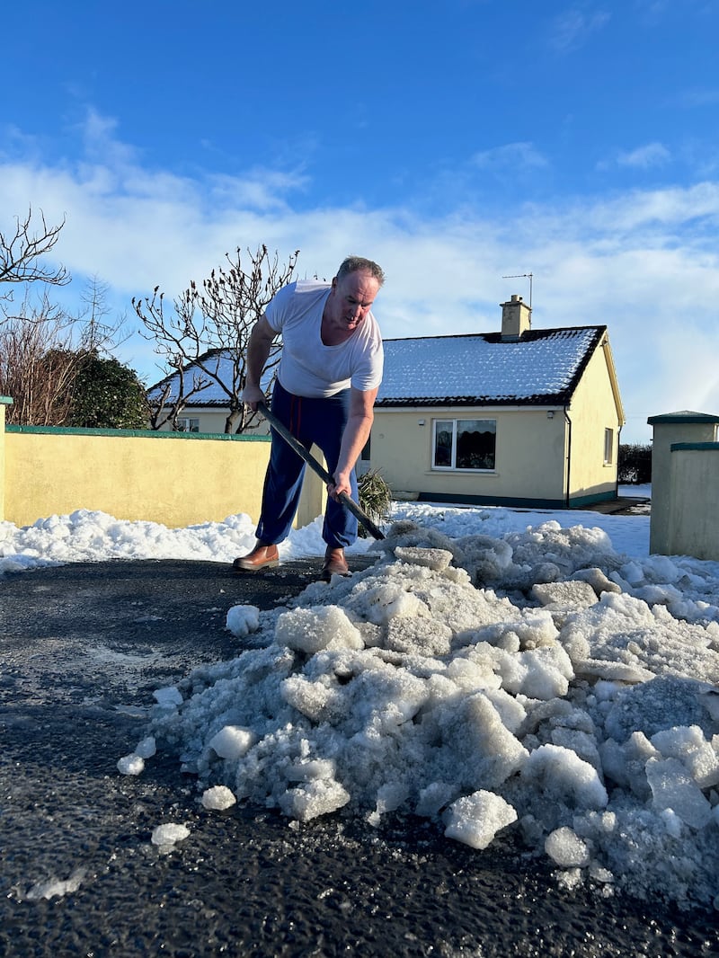 Sean Copse, of Newcastle West, Co Limerick, clears snow and ice outside his home on Thursday. Photograph: David Raleigh