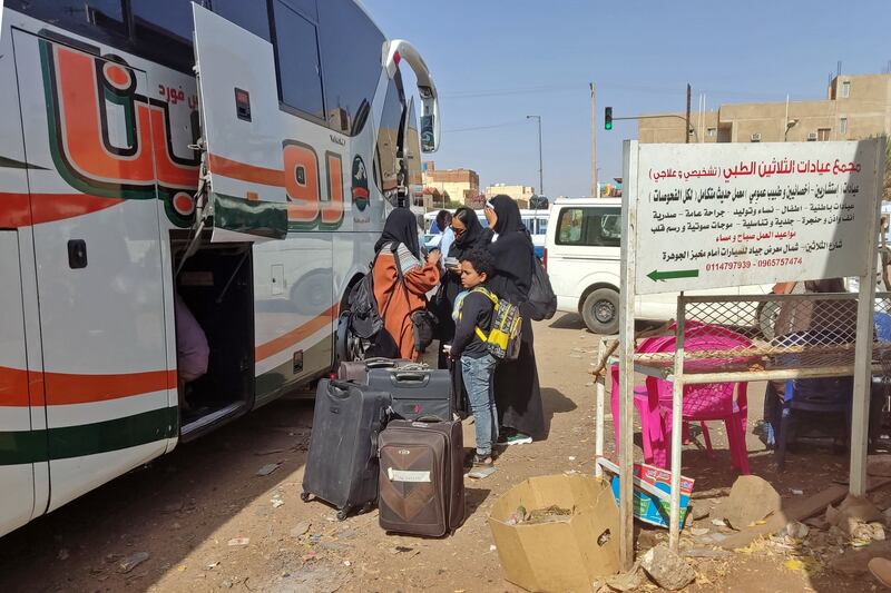 People wait with their luggage at a bus stop in southern Khartoum on May 8th as they attempt to leave the city. Photograph: AFP via Getty Images