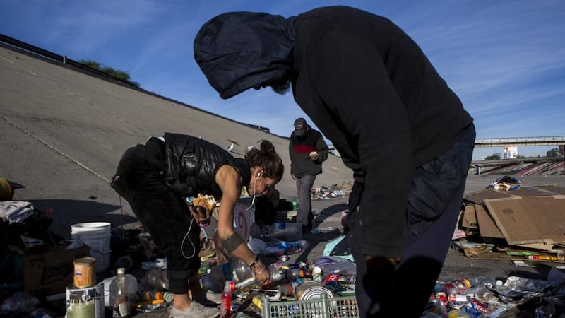 Residents separate trash for recycling at El Bordo in Tijuana, Mexico. “El Bordo” is a catch basin for the drug addicted and the deported, sometimes both, near the US-Mexico border. Photograph: Adriana Zehbrauskas/The New York Times