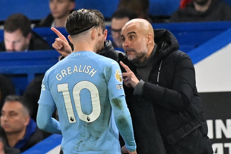 Manchester City manager Pep Guardiola speaks with Jack Grealish in November 2023. The player was subbed on in the 84th minute against West Ham United. Photograph: Glyn Kirk/AFP/Getty Images