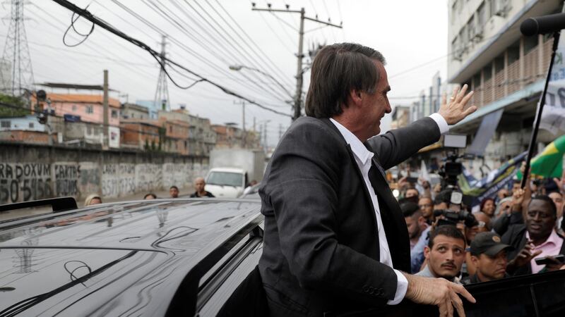 Presidential candidate Jair Bolsonaro gets into his car after attending a rally at the  popular  Mercadao de Madureira market in Rio de Janeiro, Brazil. Photograph: Ricardo Moraes/Reuters