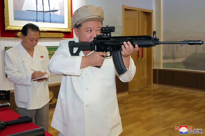 North Korean leader Kim Jong-un holds a weapon during his three-day inspection at major munitions factories in the country. Photograph: Korean Central News Agency/Korea News Service via AP