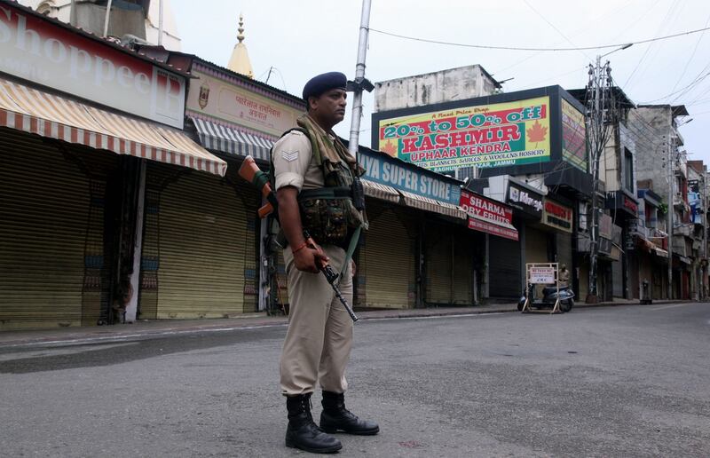 A security personnel stands guard next to closed shops in Jammu on Wednesday. Photograph:  Rakesh Bakshi/AFP/Getty Images