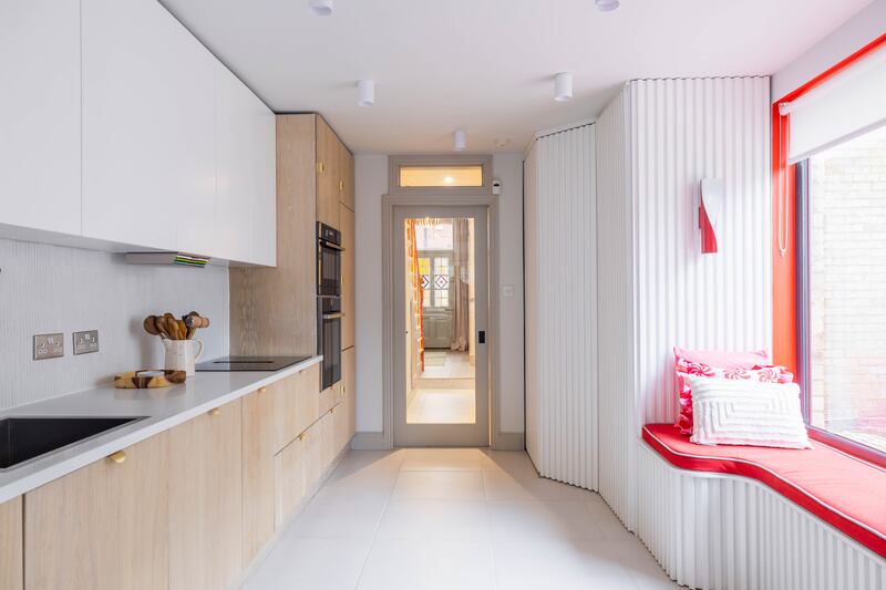 Veiw from the kitchen with its limed oak finish and quartz countertops to the hall and leaded glass panelled front door