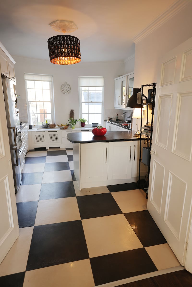 The dual-aspect kitchen has a bowed back wall with twin six-over-six pane sash windows, a details that is mirrored in the dining room to the front. Its bone-white units have black granite-look countertops with a visceral giant tomato red tureen by Bordallo Pinheiro making a statement on the island. Price €160, Howbert and Mays. Atop another surface is an LED set of ceramic fangs in pink, €4.50, Flying Tiger