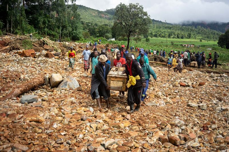 Men carry a coffin along a makeshift path on the river in the Ngangu township in eastern Zimbabwe, after the area was hit by the cyclone Idai. Photograph: Zinyange Auntony AFP/Getty