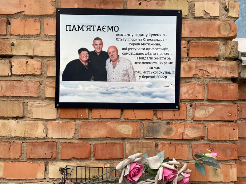 A memorial plaque in Motyzhyn village to former mayor Olha Sukhenko, whom Russian troops murdered and left in a mass grave with husband Ihor and son Oleksandr. Photograph: Daniel McLaughlin