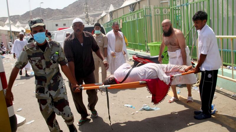 Hajj pilgrims and Saudi Arabian emergency personnel carry a woman on a stretcher at the site of a deadly  stampede in Mina, near the holy city of Mecca, at the annual hajj in Saudi Arabia on September 24th, 2015. Photograph:  AFP/Getty Images