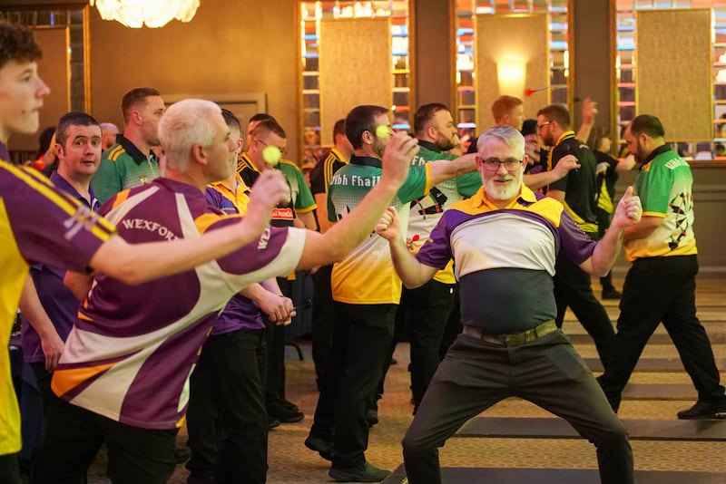 A Wexford darts player celebrates his team making it to the knockout stages of the Leinster county darts championship. Photograph: Enda O'Dowd