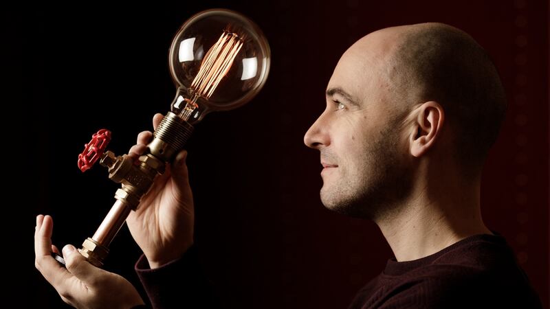 Kopper Kreation founder Emmet Bossonet with one of his copper light fittings