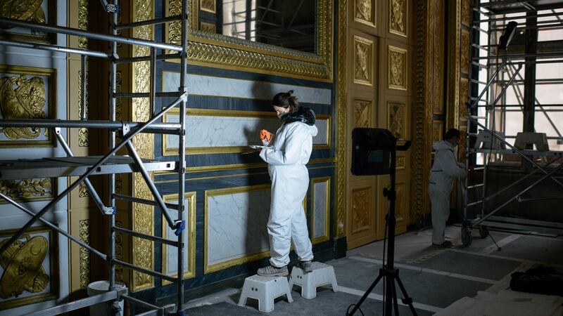 Art restorers at work at the Louvre. Photograph: Dmitry Kostyukov/The New York Times