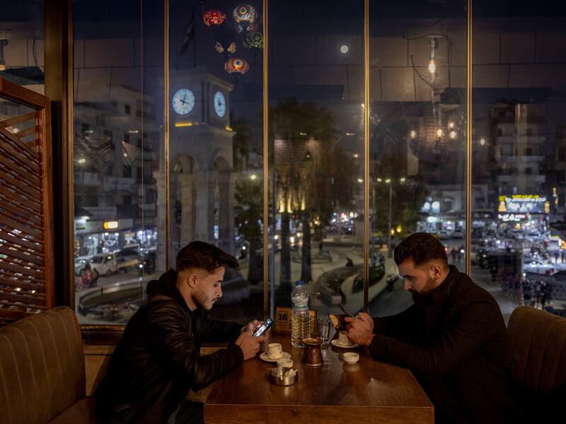 Two men have coffee in the Shababeek cafe in Idlib, Syria. Photograph: Ivor Prickett/New York Times
                      