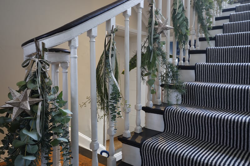 Bannisters: Swags made of eucalyptus, different types of pine (use cut-offs from your tree, says Moyna) champagne and fir-coloured velvet ribbons (Nordic Elements) and gold stars. Photograph: Nick Bradshaw