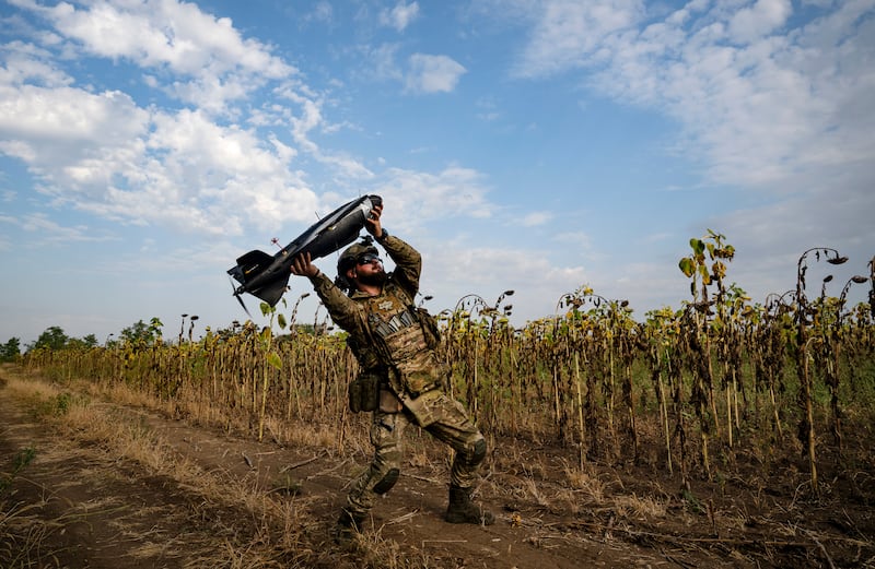 A Ukrainian soldier preparing to release a drone that will fly over Russian-occupied territory in search of heavy weapons and air defence installations. Photograph: New York Times 
                      