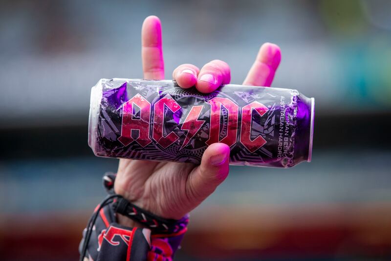 An AC/DC fan holds a branded drink can during the gig at Croke Park. Photograph: Tom Honan 