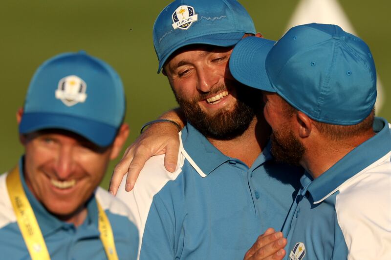 Jon Rahm of Team Europe is congratulated by team-mate Shane Lowry. Photograph: Patrick Smith/Getty