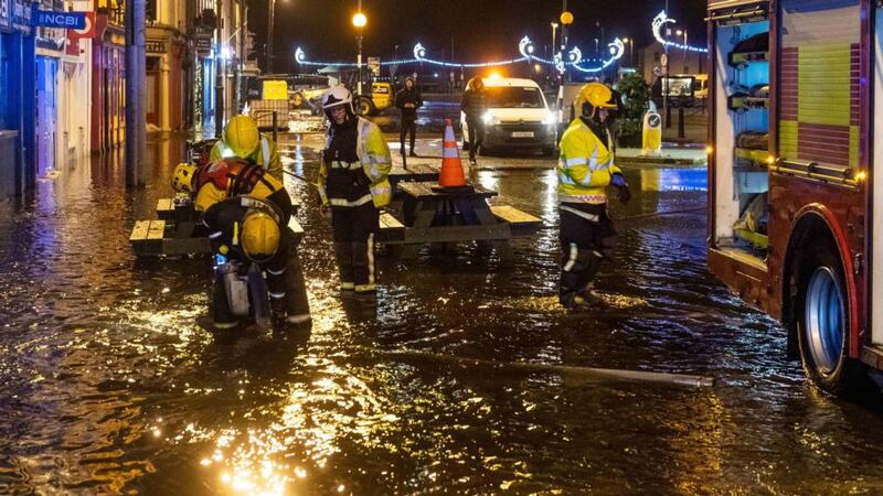 Members of the fire brigade pump away floodwater in Bantry, Co Cork, after Storm Barra hit Ireland with disruptive winds, heavy rain and snow. Photograph: Andy Gibson/PA