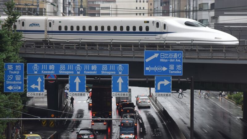 A  bullet train moves  above traffic in Tokyo. Photograph: Kazuhiro Nogi/AFP/Getty Images