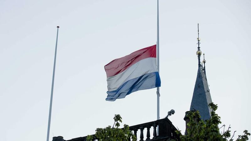 The Dutch flag flies at half mast on the building of the Dutch parliament in The Hague, The Netherlands today for a day of national mourning. Photograph Bart Maat/EPA