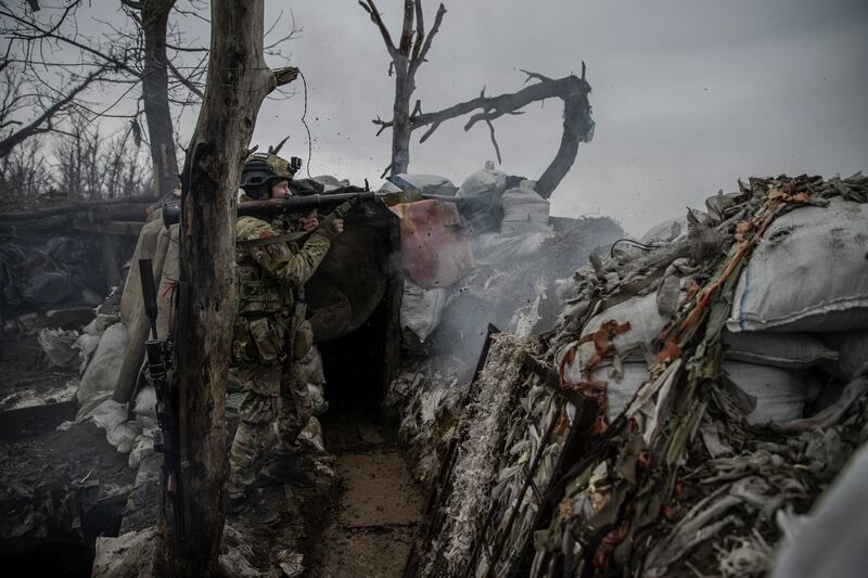 Boghdan, a Ukrainian soldier with the 79th Air Assault Brigade, fires a rocket-propelled grenade toward Russian forces from a trench in an area of Marinka, in eastern Ukraine. Photograph: Tyler Hicks/New York Times