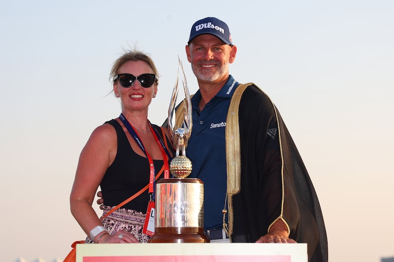 Paul Waring and his wife Claire pose with the trophy on the 18th green. Photograph: Andrew Redington/Getty Images