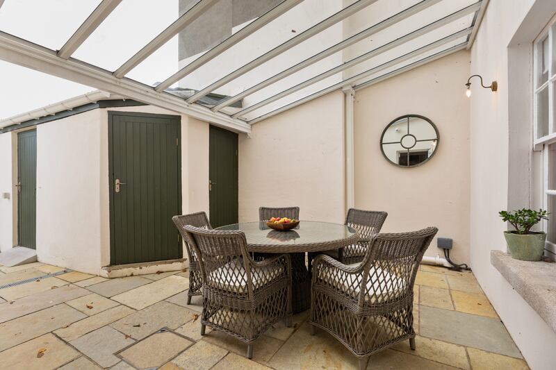 Near the house is a sheltered patio area for all-weather almost-outdoor dining.