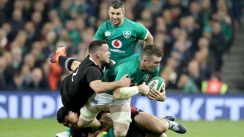 Ireland’s Peter O’Mahony is tackled by  Codie Taylor and Ryan Crotty of New Zealand. Photograph: Dan Sheridan/Inpho