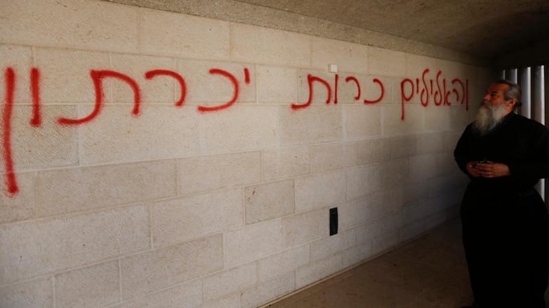 Graffiti sprayed on the wall of the complex of Church of Loaves and Fishes, reading in Hebrew: ‘Denounced the worship of idols’. Photograph: Atef Safadi/EPA