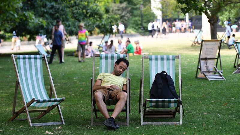 A man falls asleep during the heat at St James Park in London on Thursday. Photograph: Andy Rain/ EPA