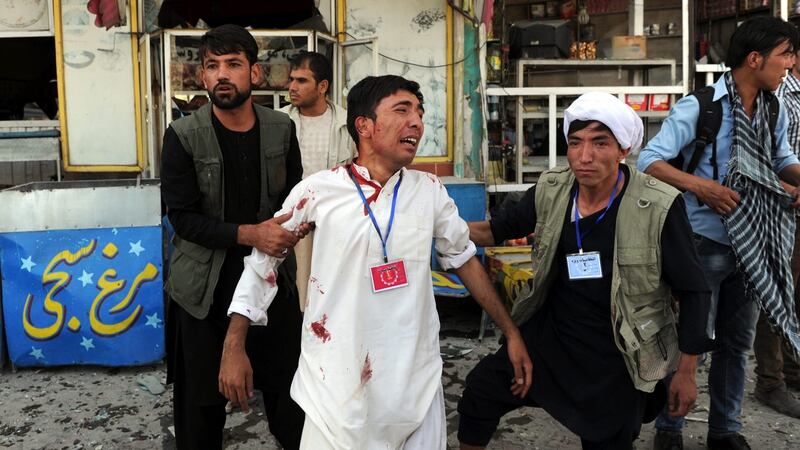 People help an injured victim after a suicide bomb targeted a demonstration of Hazara minority in Kabul, Afghanistan. Photograph: Hedayatullah Amid/EPA