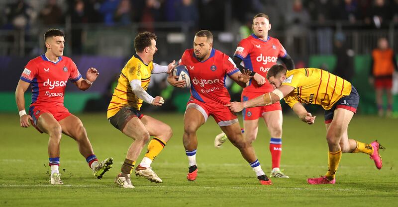 Ollie Lawrence of Bath is tackled by Stuart McCloskey and Billy Burns. Photograph: David Rogers/Getty