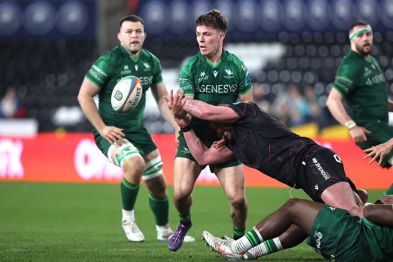 Connacht's Matthew Devine offloads under pressure during the BKT United Rugby Championship match against the Ospreys at Swansea.com Stadium. Photograph: Bryan Keane/Inpho