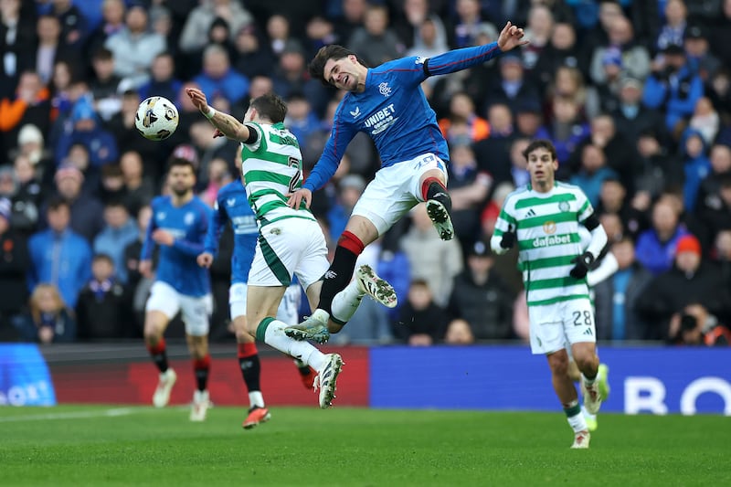 Ianis Hagi of Rangers and Alistair Johnston of Celtic battle for a header. Photograph: Ian MacNicol/Getty