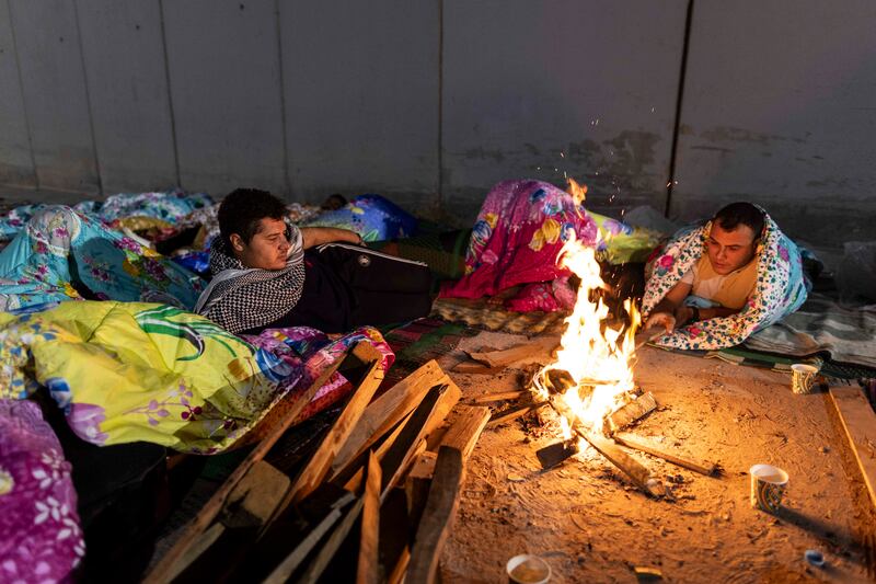 Volunteers and NGO staff camp in front of the Rafah border as they wait to deliver aid supplies to Gaza on October 19th, 2023, in north Sinai, Egypt. Photograph: Mahmoud Khaled/Getty Images