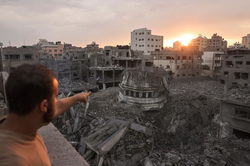 A Palestinian points to the Ahmed Yassin mosque, which was levelled by Israeli airstrikes, in Gaza City early on Monday. Photograph: Mohammed Abed/AFP via Getty Images