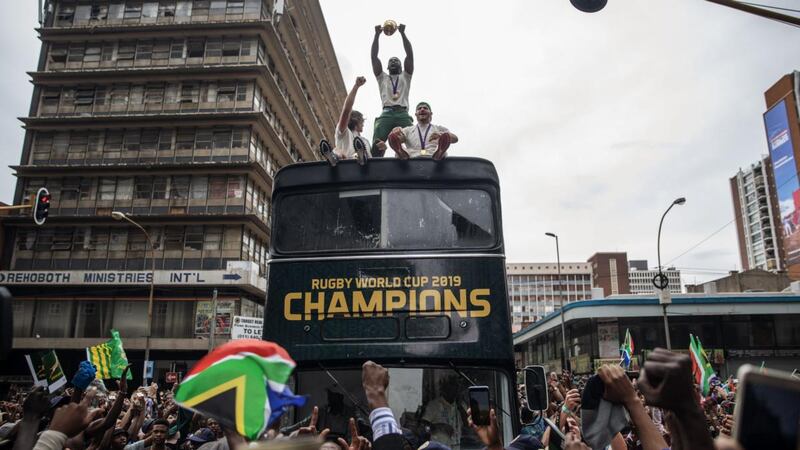 South African rugby captain Siya Kolisi ) holds up the Web Ellis trophy as the team parades through the streets of Johannesburg on Thursday. Photograph:  Michele Spatari/AFP via Getty Images