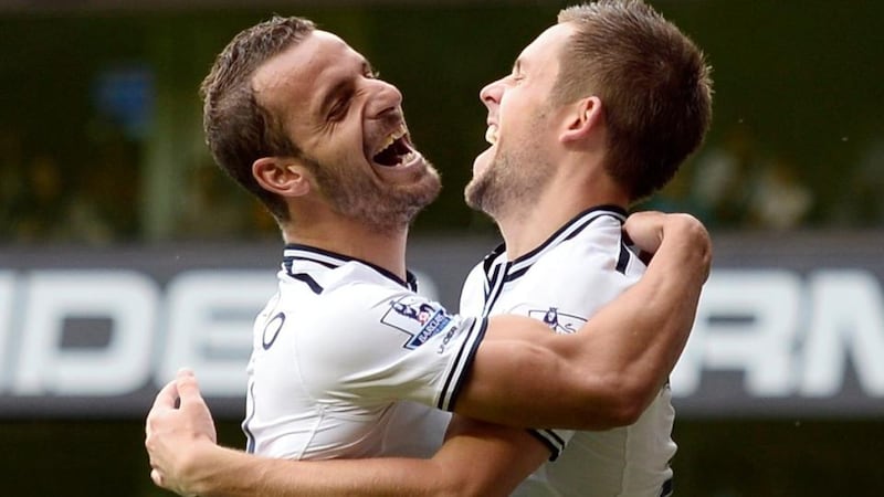 Tottenham Hotspur’s Gylfi Sigurdsson (right) celebrates with-team mate Roberto Soldado after scoring his  second goal in the 2-0 Premier League victory over Norwich City at White Hart Lane. Photograph: Dylan Martinez/Reuters.