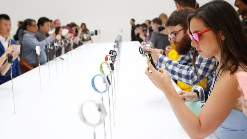 Members of the media photograph and examine the Apple Watch during Apple’s launch event at the Flint Center  in Cupertino, California. Photograph: EPA