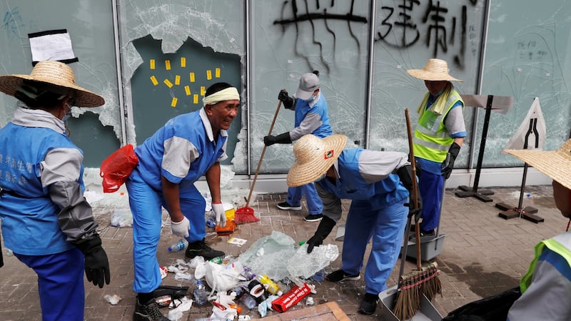 Workers clean up outside the Legislative Council, a day after protesters broke into the building in Hong Kong. Photograph: Jorge Silva/Reuters