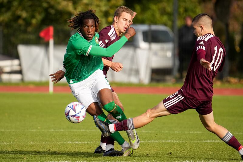 Ireland's Bosun Lawal in action against Artjoms Puzirevskis and Lukass Vapne of Latvia. Photograph: Edijis Palens/Inpho 