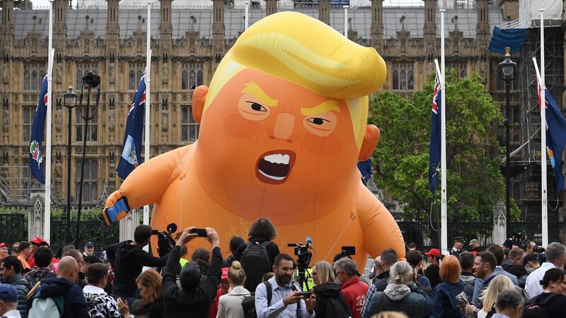 Anti-Trump protesters with a Trump baby blimp flying over Parliament Square gather for a protest against US President Donald Trump’s State visit to the UK. Photograph: Andy Rain/EPA