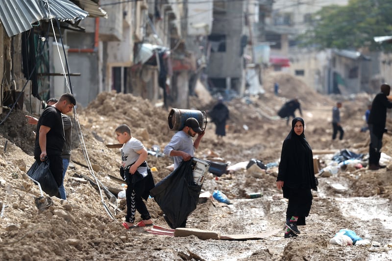 Residents of the Tulkarem refugee camp in the occupied West Bank carry their belongings as they evacuate their homes amid the ongoing Israeli military operation. Photograph: Alaa Bederneh/EPA-EFE