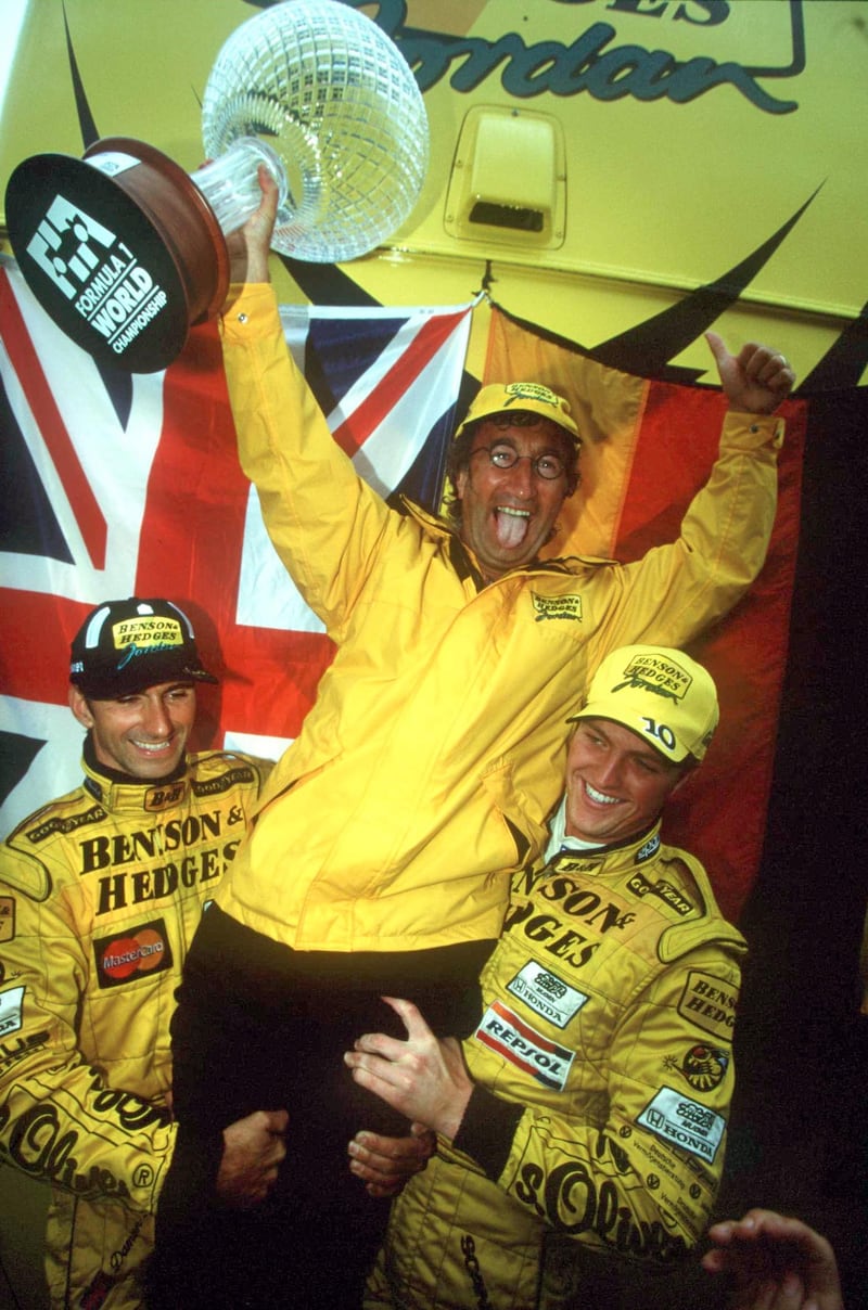 Eddie Jordan is held aloft by Jordan drivers Damon Hill (left) and Ralf Schumacher after their one-two finish in the 1998 Belgian GP. Photograph: Inpho/Allsport