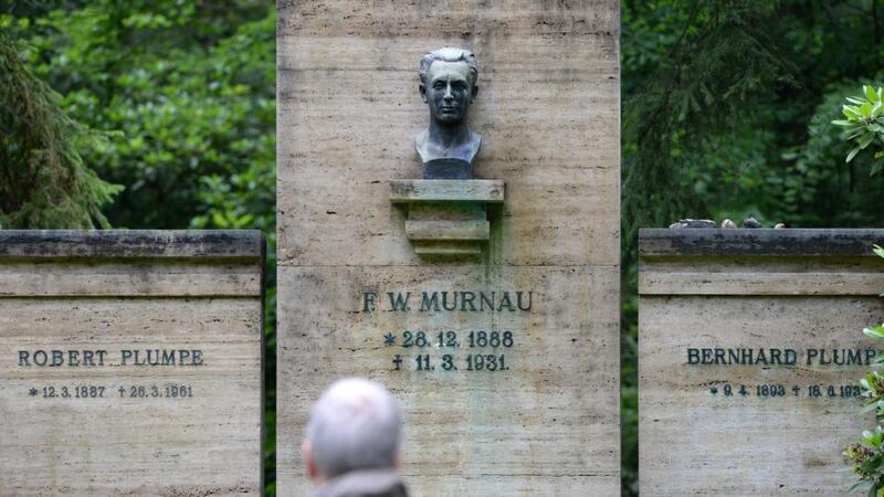 A man looks at a crypt of the Murnau and Plumpe families  in Stahnsdorf, Germany. Grave robbers have stolen from a crypt the head of German expressionist cinema great Friedrich Wilhelm Murnau, director of the silent-film vampire classic ‘Nosferatu’. Photograph: Ralf Hirschberger/AFP /Getty Images