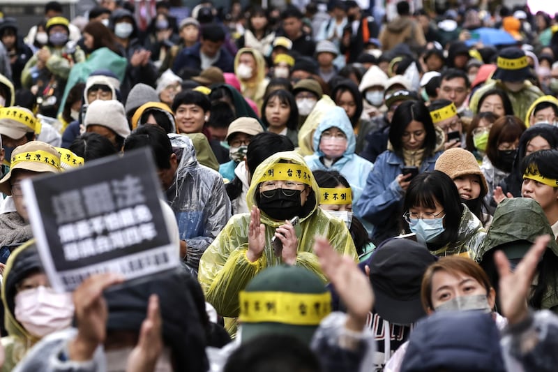 Demonstrators shout slogans and display placards during a protest against three bills proposed by Taiwan's opposition parties, outside the Parliament building in Taipei, Taiwan. Photograph: Richie B Tongo/EPA-EFE