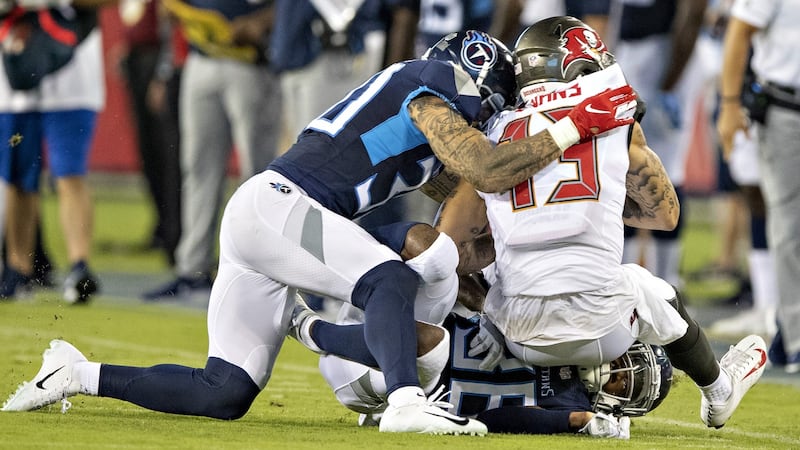 Kenny Vaccaro of the Tennessee Titans hits Mike Evans of the Tampa Bay Buccaneers and is called for helmet to helmet contact penalty. Photograph:  Wesley Hitt/Getty Images