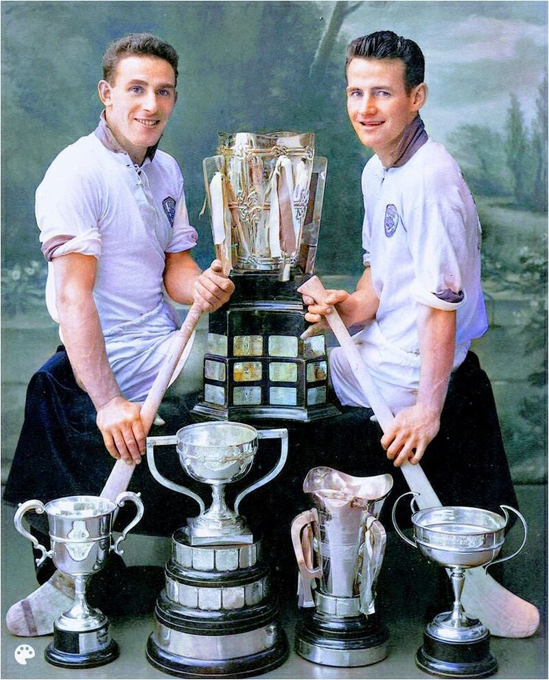 Larry Guinan and Frankie Walsh with the Liam MacCarthy Cup and the other trophies they won that year. Photograph: Waterford News & Star and coloured by Ian Hannigan