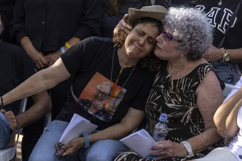 Former Hamas hostages Ruti (right) and Keren Munder grieve during the funeral of their late husband and father Avraham Munder, one of the hostages taken captive during the October 7th Hamas-led attack on Israel, and whose body was recovered from Gaza last August. Photograph: Menahem Kahana/AFP via Getty Images