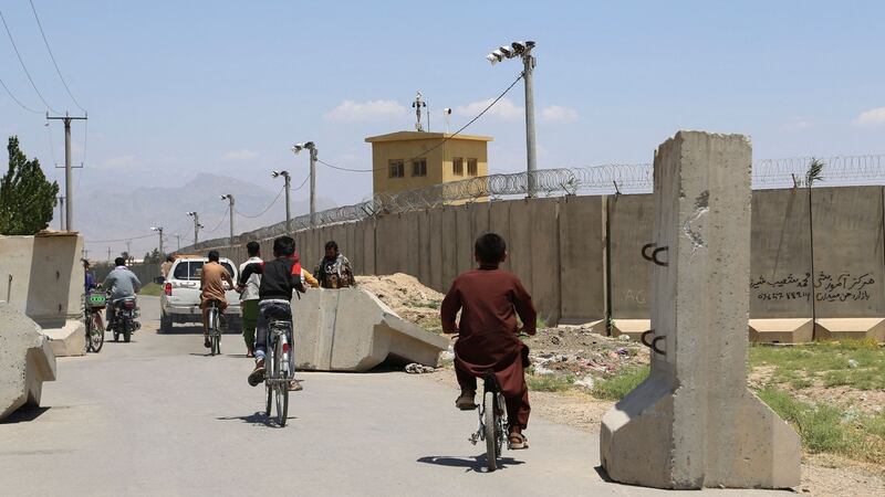 Children ride bicycles past a road checkpoint outside Bagram air base, some 70km north of Kabul, after all US and Nato troops left. Photograph:   Zakeria Hashimi/AFP via Getty Images